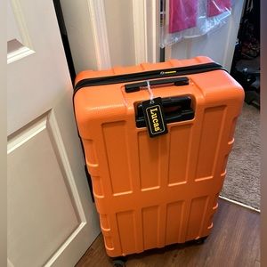 Oversized suitcase with tags